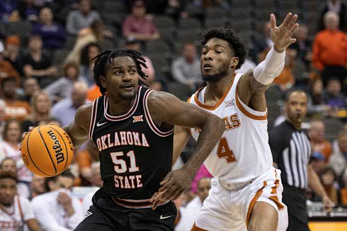 Oklahoma State Cowboys guard John-Michael Wright (51) handles the ball while defended by Texas Longhorns guard Tyrese Hunter (4) in the first half at T-Mobile Center.